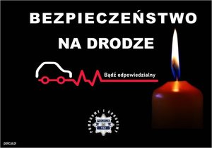 plakat z napisem na czarnym tle &quot;Bezpieczeństwo na drodze&quot;, z prawej strony zapalona świeca