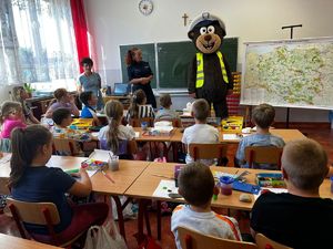 Policjanci oraz miś POPO z przedszkolakami