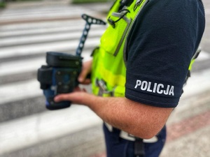 Policjant z miernikiem prędkości w ręku
